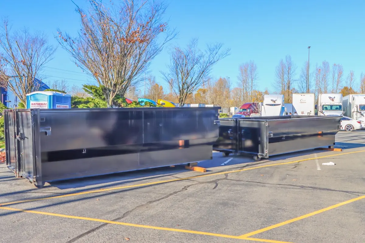 Professional dumpster rental service with roll-off container on residential driveway in Platteville